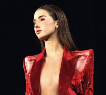 Mel Stanger '23 at New York Fashion Week, modeling the red suit that shows women’s empowerment.